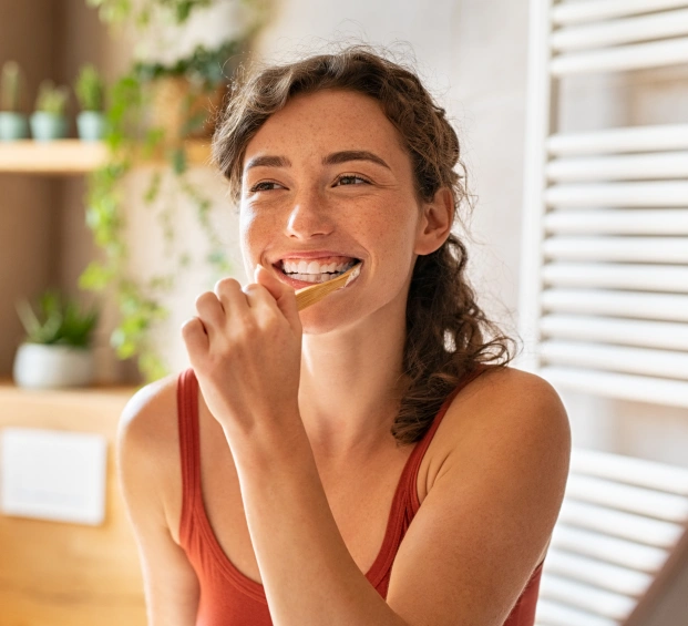Smiling woman promoting biological dentistry and whole-body oral health