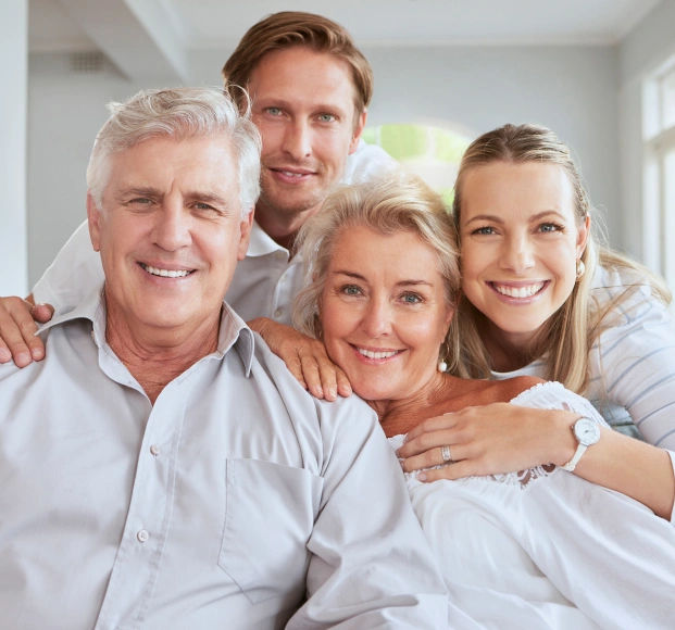 Happy family smiling after receiving dental care for every stage of life