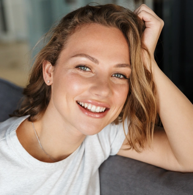 Smiling woman showcasing the results of a personalized smile makeover