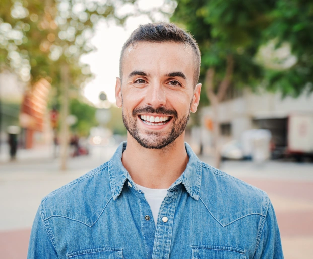 Smiling patient with a brighter smile after professional teeth whitening treatment